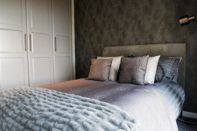 Kleines Modernes Hauptschlafzimmer ohne Kamin mit grauer Wandfarbe, Teppichboden, grauem Boden, Tapetendecke und Tapetenwänden in London