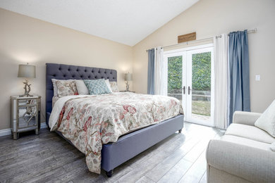 Inspiration for a contemporary master laminate floor and gray floor bedroom remodel in Los Angeles with beige walls
