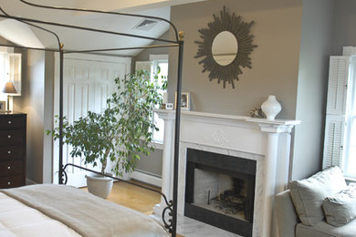 Mid-sized elegant master light wood floor bedroom photo in Providence with gray walls, a standard fireplace and a stone fireplace