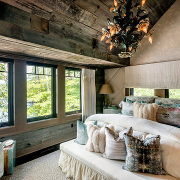 Master bedroom with dramatic reclaimed wood ceiling and integrated headboard wal