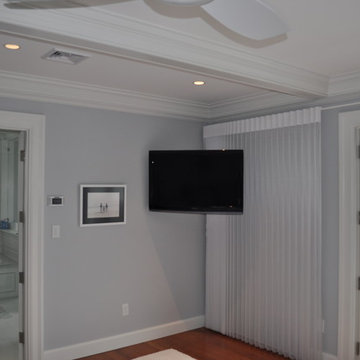 Master Bedroom with TV Mounted in Corner