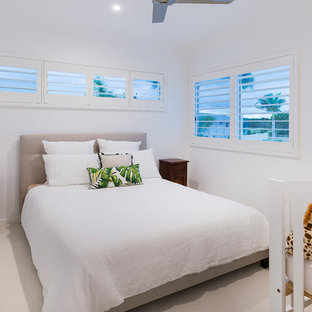 Photo of a small beach style guest bedroom in Gold Coast - Tweed with white walls, carpet and beige floor.