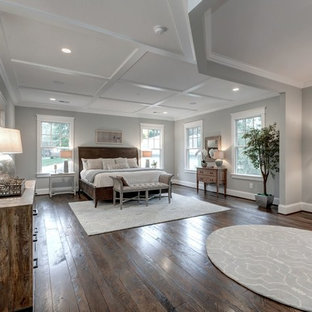 Example of a large country master dark wood floor bedroom design in DC Metro with gray walls and no fireplace