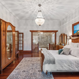 Photo of a large traditional master bedroom in Perth with grey walls, dark hardwood floors, brown floor and no fireplace.