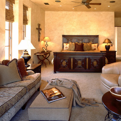 Tuscan master carpeted bedroom photo in Atlanta with beige walls