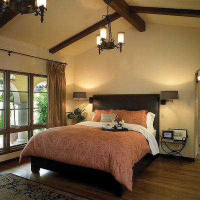 Bedroom - mediterranean dark wood floor bedroom idea in Los Angeles with beige walls