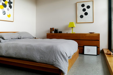 Scandi guest bedroom in Melbourne with concrete flooring.