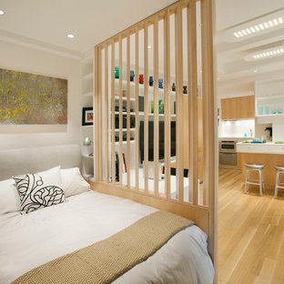 Bedroom - small scandinavian master light wood floor and brown floor bedroom idea in New York with white walls and no fireplace