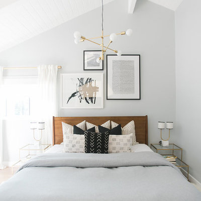 Inspiration for a large scandinavian master light wood floor bedroom remodel in Orange County with gray walls and no fireplace