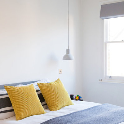 Bedroom - contemporary bedroom idea in London with white walls