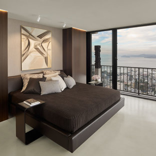 Foto de dormitorio tipo loft, minimalista, pequeño, sin chimenea, con paredes grises y suelo de cemento