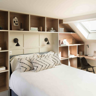 This is an example of a large contemporary guest bedroom in Essex with grey walls, carpet and grey floors.