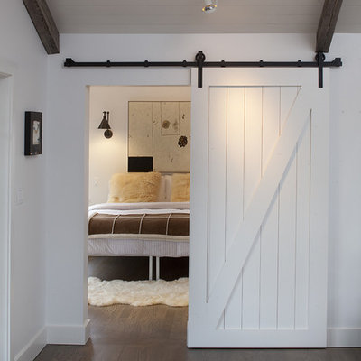 Inspiration for a country dark wood floor bedroom remodel in San Francisco with white walls