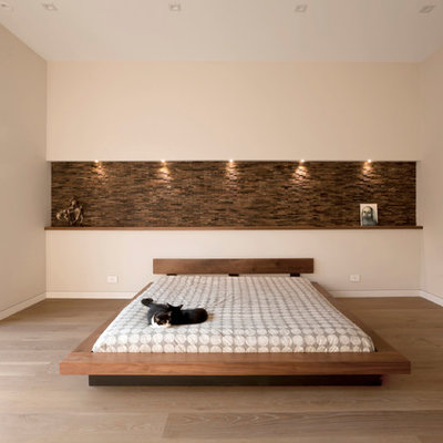 Inspiration for a mid-sized contemporary master medium tone wood floor and brown floor bedroom remodel in Chicago with beige walls
