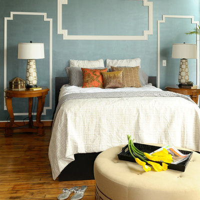 Example of a minimalist medium tone wood floor bedroom design in Minneapolis with blue walls