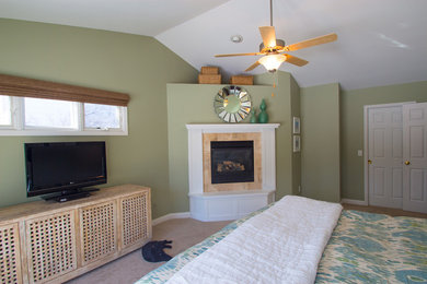 Mid-sized elegant master carpeted bedroom photo in Minneapolis with green walls, a standard fireplace and a wood fireplace surround