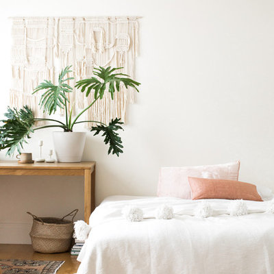Inspiration for a large scandinavian master light wood floor and beige floor bedroom remodel in New York with white walls and no fireplace