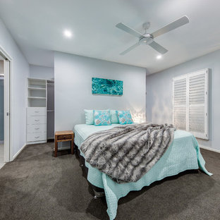 This is an example of a mid-sized contemporary master bedroom in Sunshine Coast with grey walls, carpet and grey floor.
