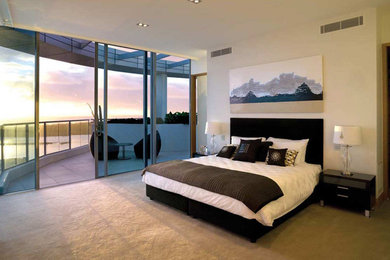 Inspiration for a large modern master carpeted bedroom remodel in Los Angeles with beige walls