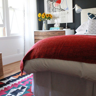 Modelo de habitación de invitados minimalista, pequeña, sin chimenea, con paredes negras y suelo de madera clara