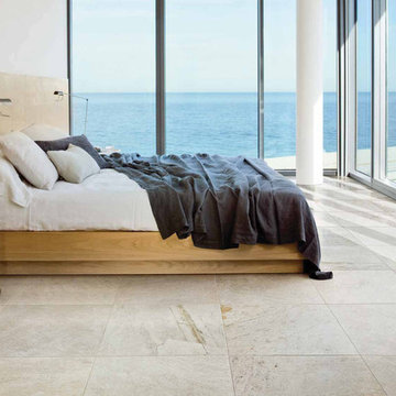Modern bedroom with soft white stone look porcelain tile floors