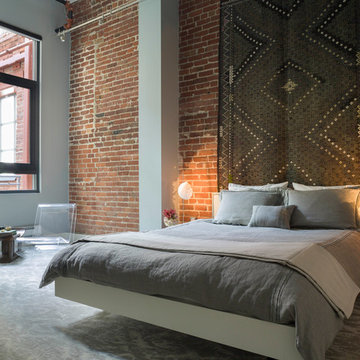 Modern Loft Bedroom with Exposed Brick + Textile Wall Art