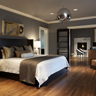 Example of a large trendy master dark wood floor and brown floor bedroom design in Seattle with gray walls and no fireplace