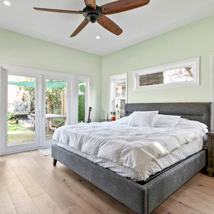 Inspiration for a mid-sized cottage master light wood floor and beige floor bedroom remodel in Los Angeles with green walls
