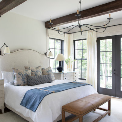 Example of a large country master light wood floor and beige floor bedroom design in Atlanta with white walls and no fireplace