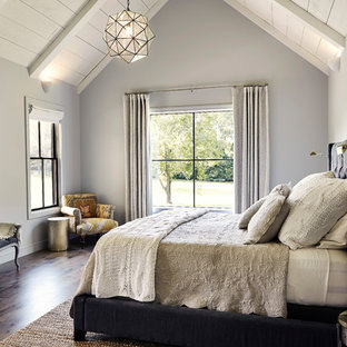 Inspiration for a mid-sized farmhouse master dark wood floor and brown floor bedroom remodel in Other with gray walls