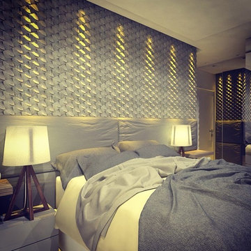 Modern grey bedroom with textured stone mosaics