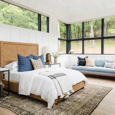 Large transitional guest light wood floor and beige floor bedroom photo in Salt Lake City with white walls