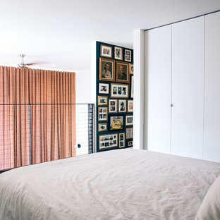 Example of a small trendy loft-style carpeted and gray floor bedroom design in San Francisco with white walls