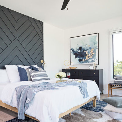 Large transitional master light wood floor and beige floor bedroom photo in Tampa with white walls
