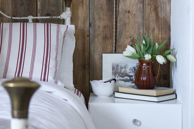 Inspiration for a rustic guest bedroom remodel in Other with white walls
