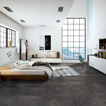 Modern white bedroom with dark grey porcelain floors