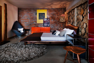 Example of an urban concrete floor bedroom design in Denver with no fireplace