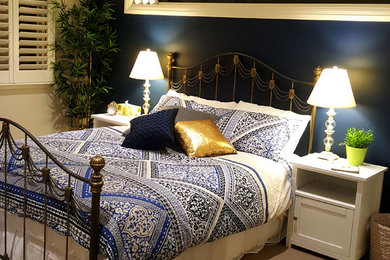 Ejemplo de habitación de invitados contemporánea de tamaño medio con paredes azules, moqueta y suelo beige