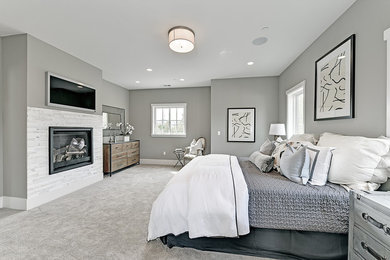 Example of a large transitional master carpeted bedroom design in San Francisco with gray walls, a standard fireplace and a stone fireplace