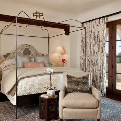 Example of a mid-sized tuscan guest dark wood floor bedroom design in Santa Barbara with beige walls and no fireplace