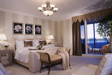 Large elegant master carpeted bedroom photo in Miami with beige walls and no fireplace