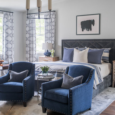 Large transitional master medium tone wood floor and brown floor bedroom photo in Atlanta with gray walls
