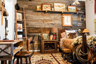Inspiration for a mid-sized rustic guest medium tone wood floor and brown floor bedroom remodel in Dallas with brown walls and no fireplace