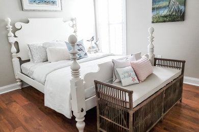 Example of a mid-sized beach style guest dark wood floor and brown floor bedroom design in Other with gray walls