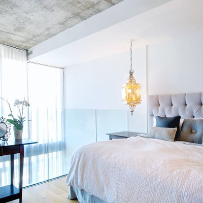 Bedroom - contemporary loft-style light wood floor bedroom idea in Toronto with white walls and no fireplace