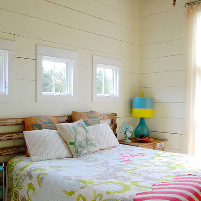 Example of a cottage medium tone wood floor bedroom design in New York with white walls and no fireplace