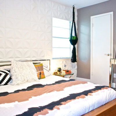 Trendy medium tone wood floor bedroom photo in Dallas with gray walls and no fireplace