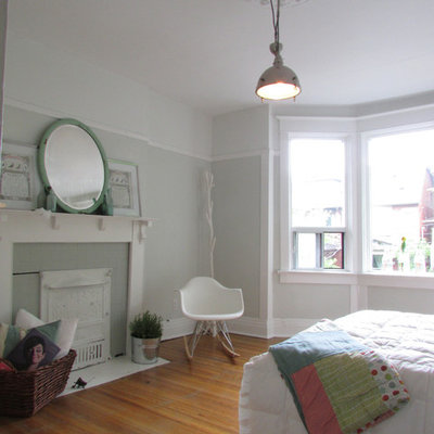 Bedroom - contemporary medium tone wood floor bedroom idea in Toronto with gray walls and a standard fireplace