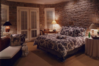 Bedroom - mid-sized rustic master carpeted and beige floor bedroom idea in Cleveland with brown walls and no fireplace