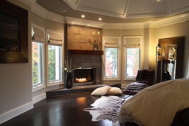 Bedroom - large contemporary master dark wood floor and brown floor bedroom idea in Atlanta with beige walls, a corner fireplace and a tile fireplace